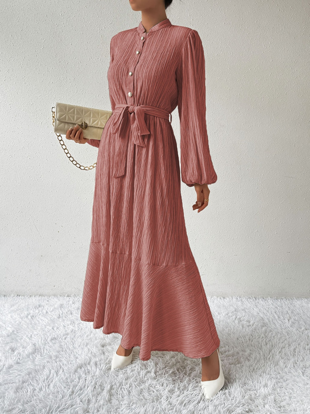 Honey tie waist long sleeve dress in a soft pink tone with button front and flowy maxi design. Made from a comfortable viscose blend, perfect for versatile fashion.