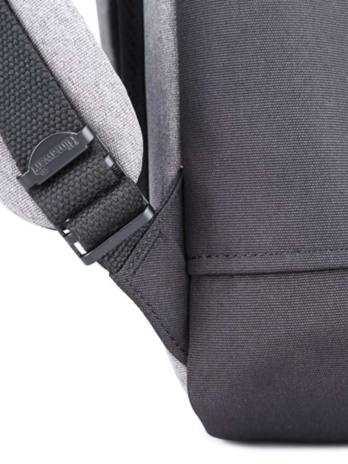 Close-up of the side strap and stitching on the Himawari waterproof canvas backpack, highlighting its durability.