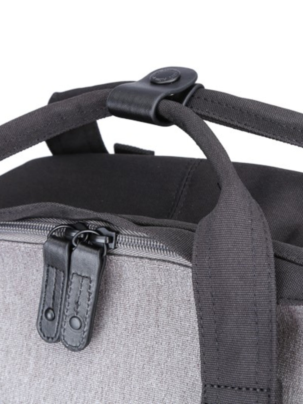 Top handle and zipper detail of the Himawari canvas backpack, emphasizing its durable and functional design.